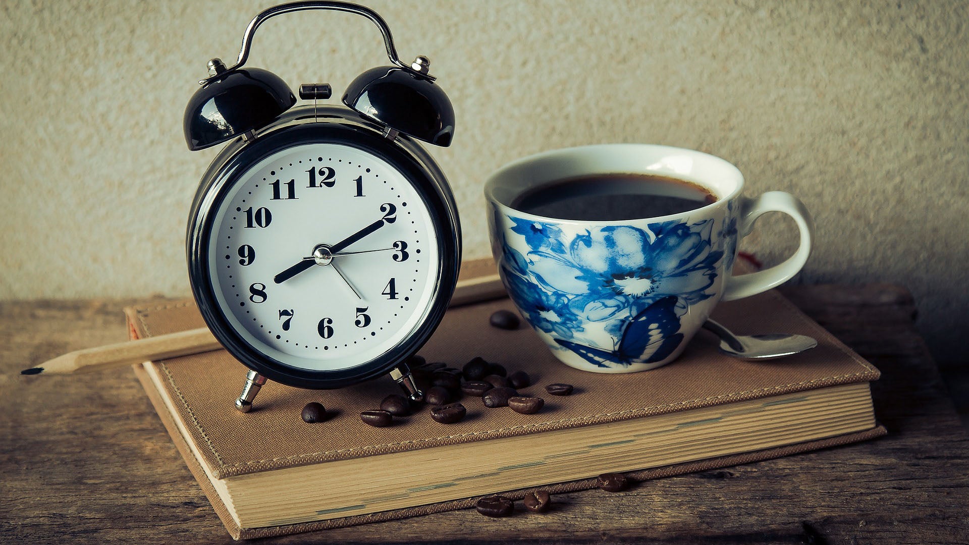 Vintage clock next to a cup of coffee